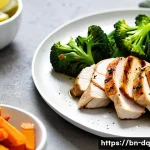 밀프렙으로 만드는 저녁 메뉴 추천 - A vibrant meal prep dinner plate featuring grilled chicken breast, steamed broccoli, and sliced carr...